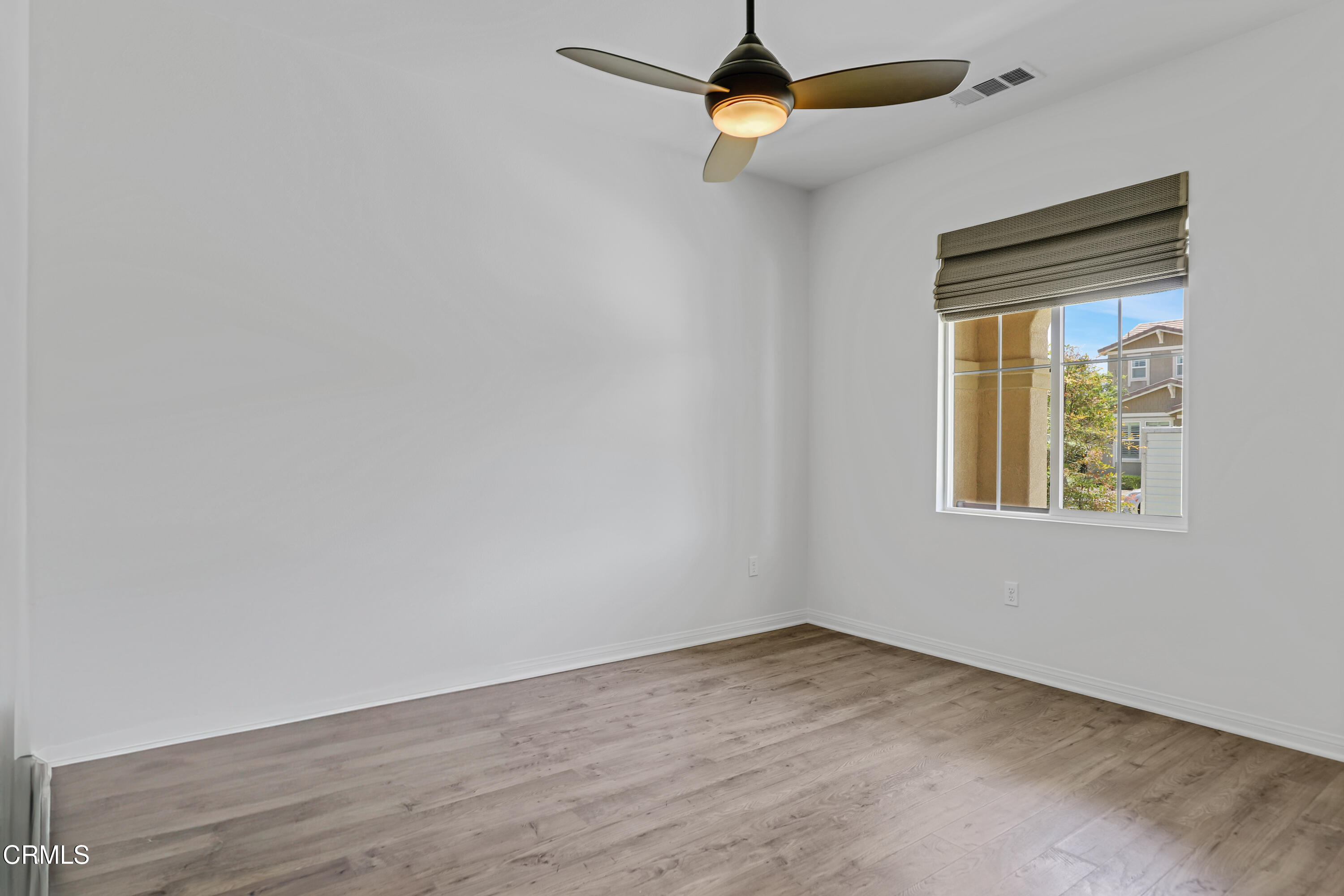 665 Tiber River Way Oxnard, CA 93036 - Photo 9 of 27 an empty room with a window and wooden floor