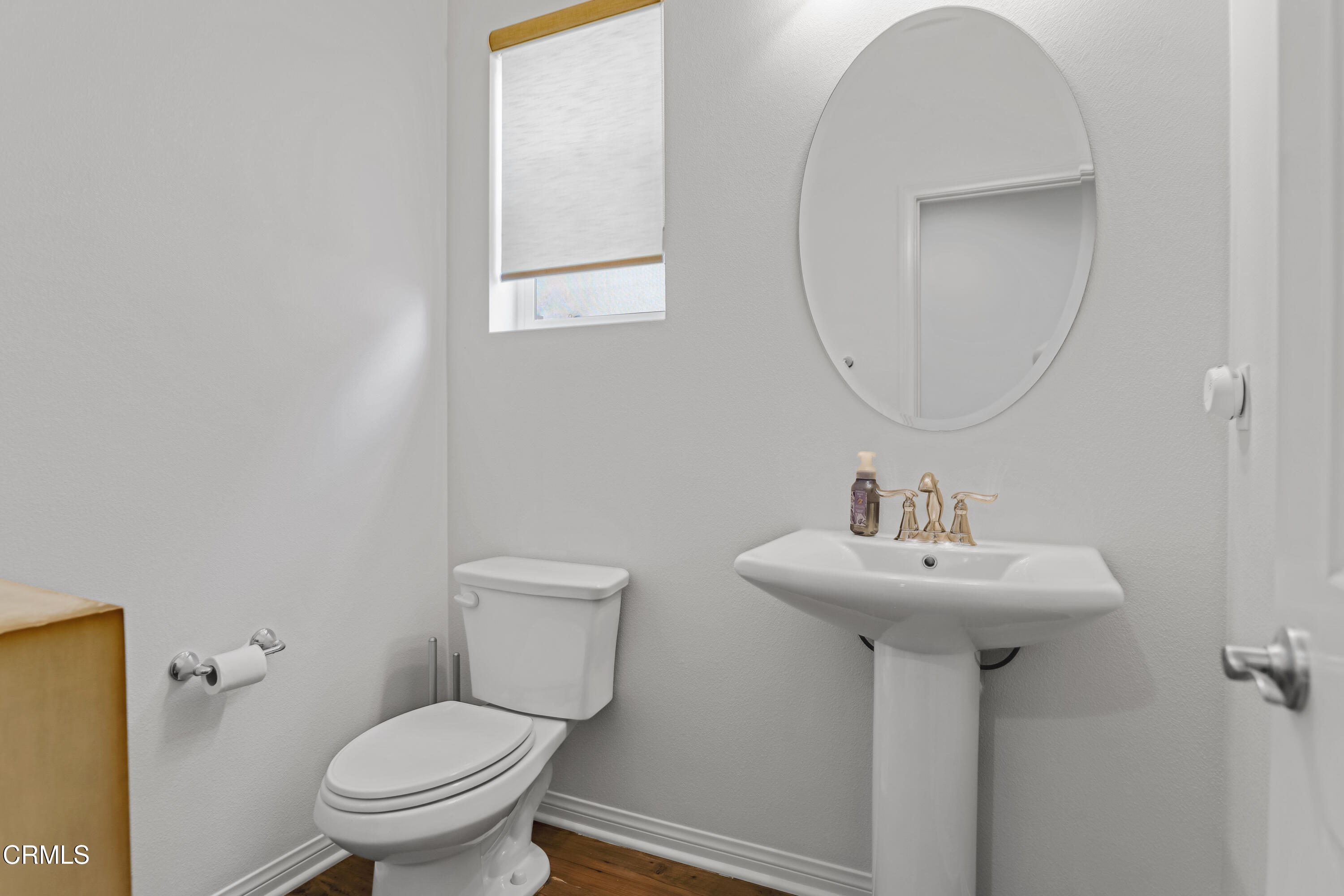 665 Tiber River Way Oxnard, CA 93036 - Photo 10 of 27 a bathroom with a toilet sink and mirror