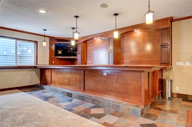 a room with wooden floor table and fireplace