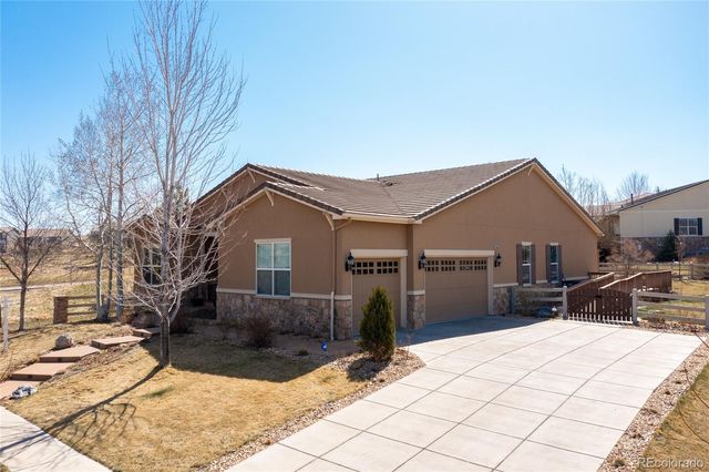 a view of a house with wooden fence