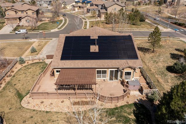 an aerial view of a house with a yard