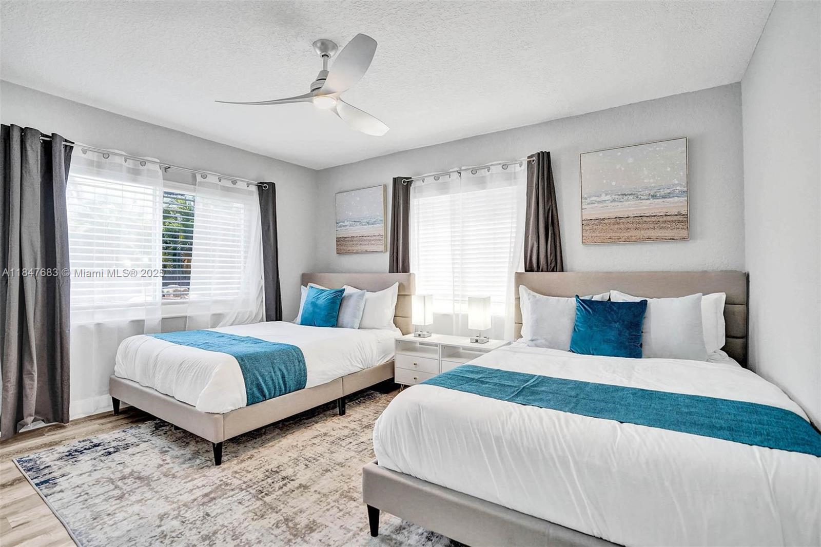 3421 Dover Road Pompano Beach, FL 33062 - Photo 35 of 83 a bedroom with two beds and a large window