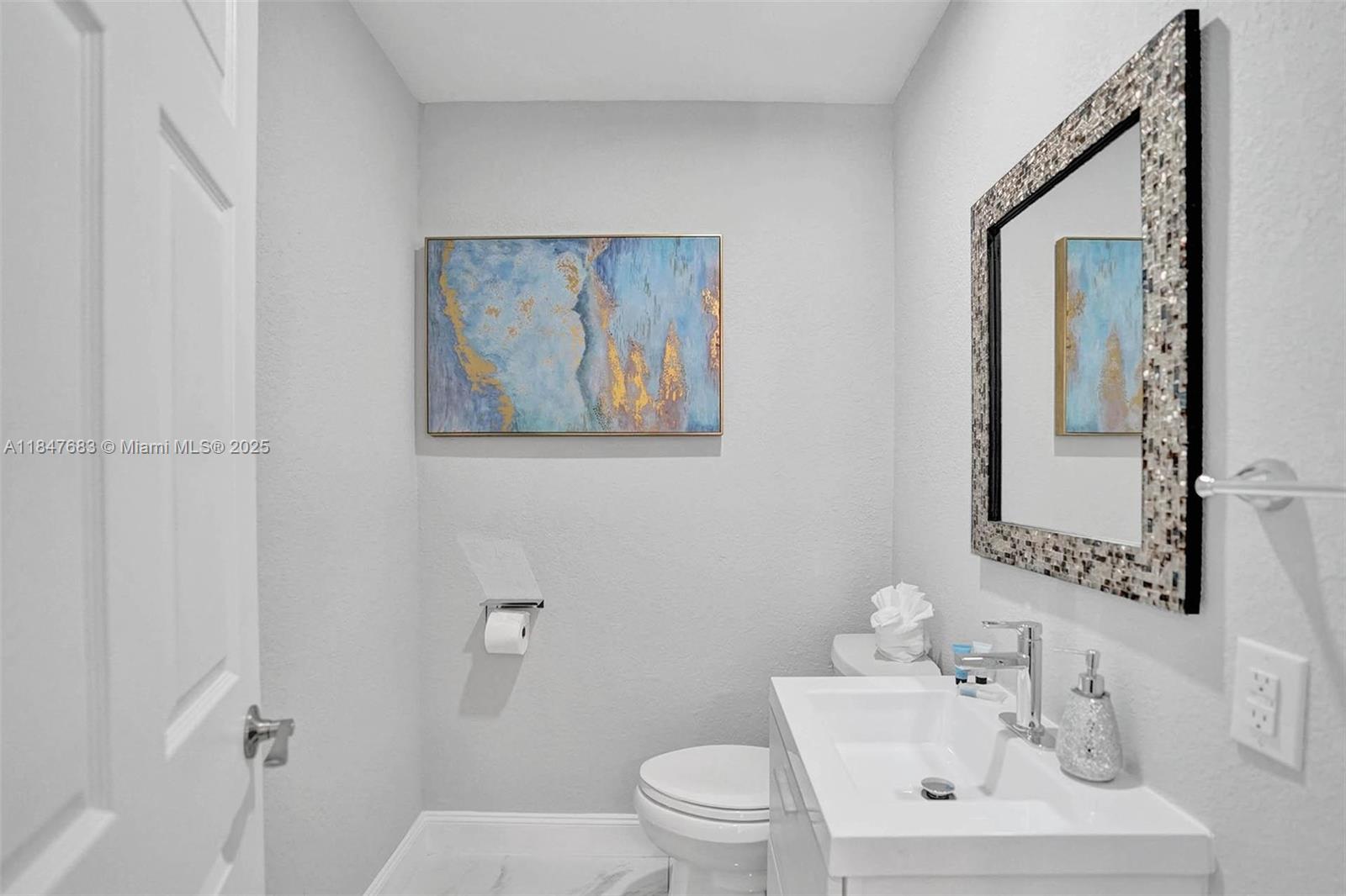 3421 Dover Road Pompano Beach, FL 33062 - Photo 9 of 83 a bathroom with a toilet a sink and mirror