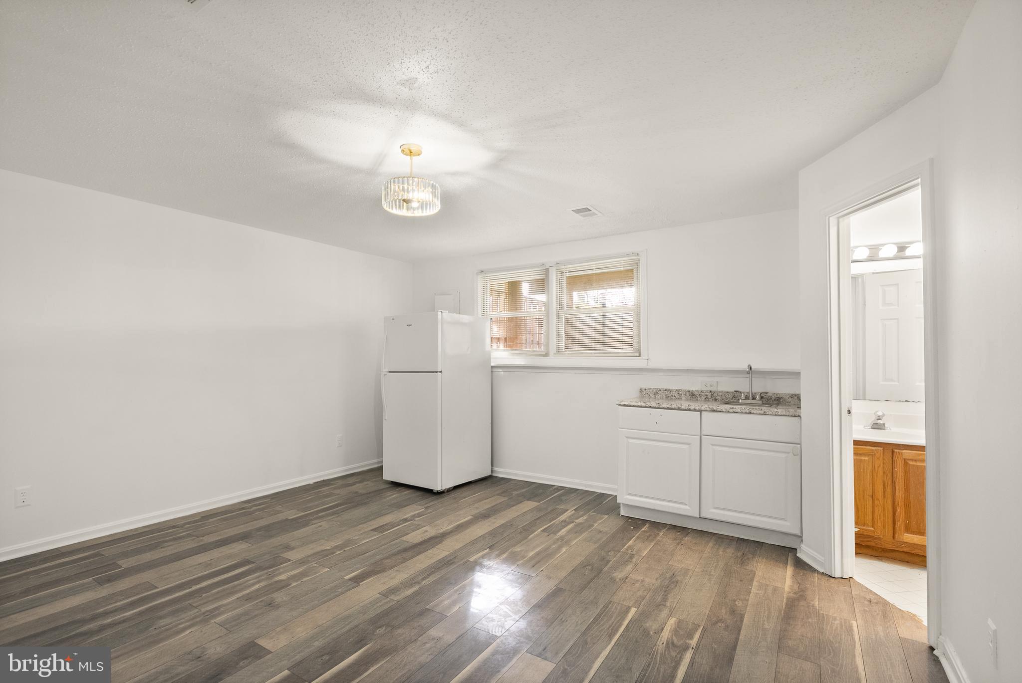 3733 Roxbury Lane Alexandria, VA 22309 - Photo 23 of 37 wooden floor in an empty room with a window