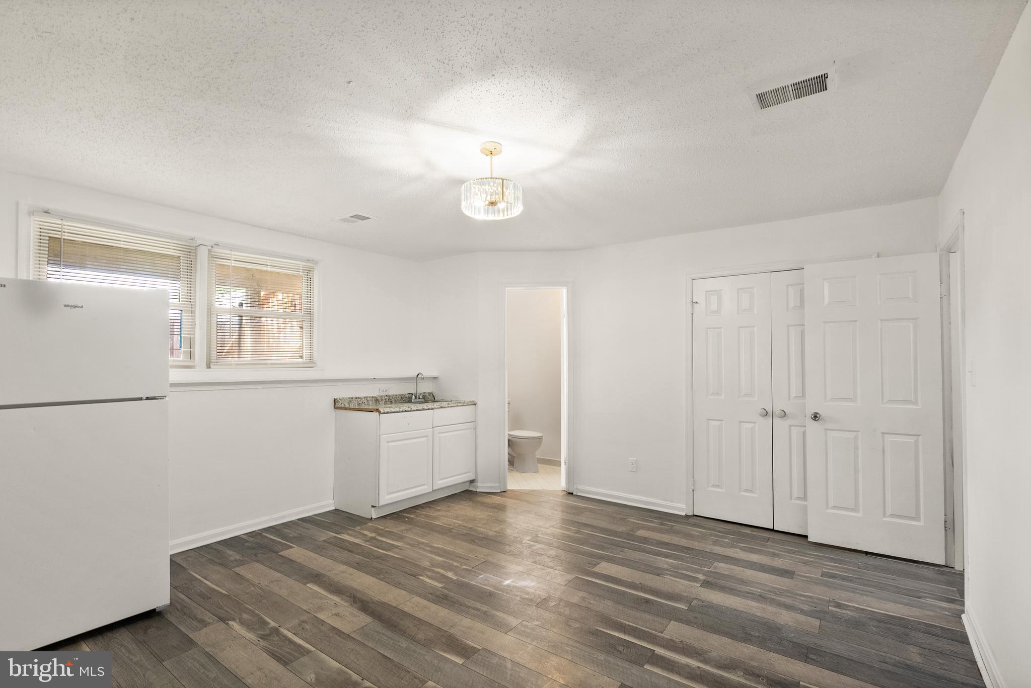 3733 Roxbury Lane Alexandria, VA 22309 - Photo 24 of 37 a view of a kitchen with a dishwasher cabinets and wooden floor