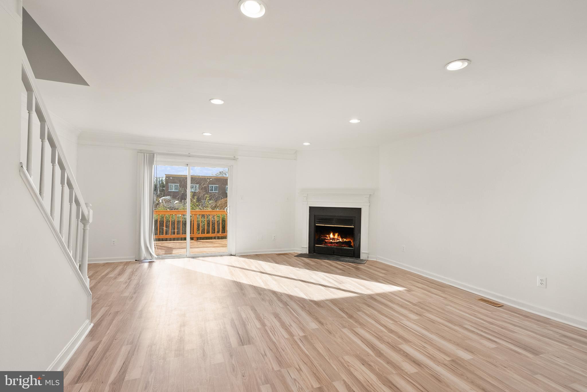 3733 Roxbury Lane Alexandria, VA 22309 - Photo 7 of 37 an empty room with wooden floor and windows