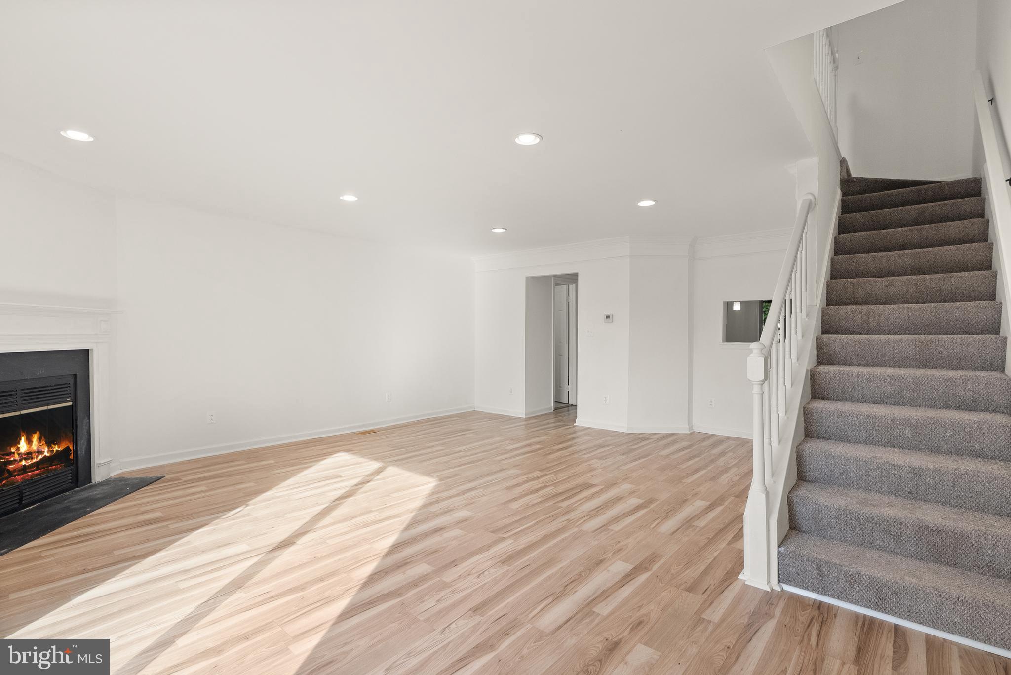 3733 Roxbury Lane Alexandria, VA 22309 - Photo 9 of 37 a view of an empty room with wooden floor and a fireplace