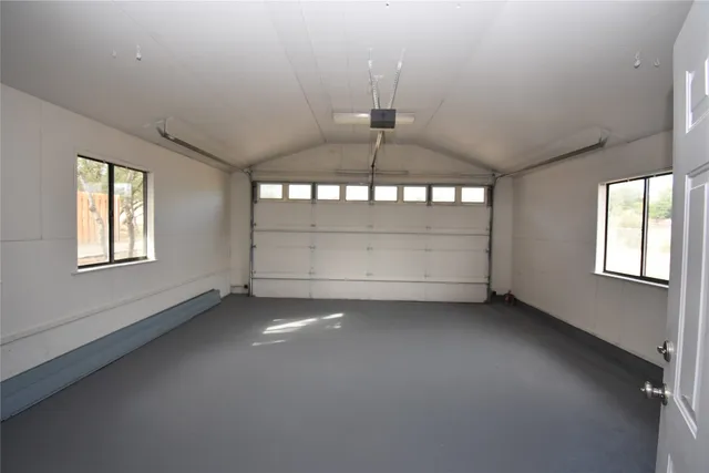 an empty room with a empty space and windows