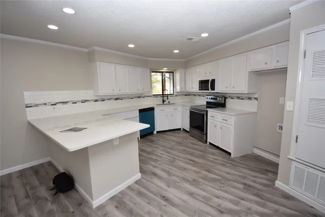 a view of a kitchen and refrigerator