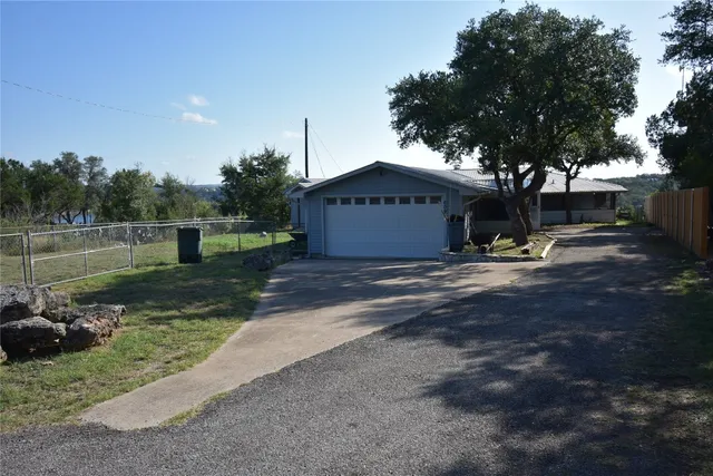 a view of a table and chairs under the tree