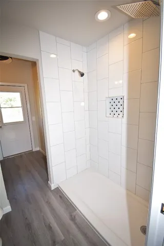 a bathroom with a bathtub and a shower