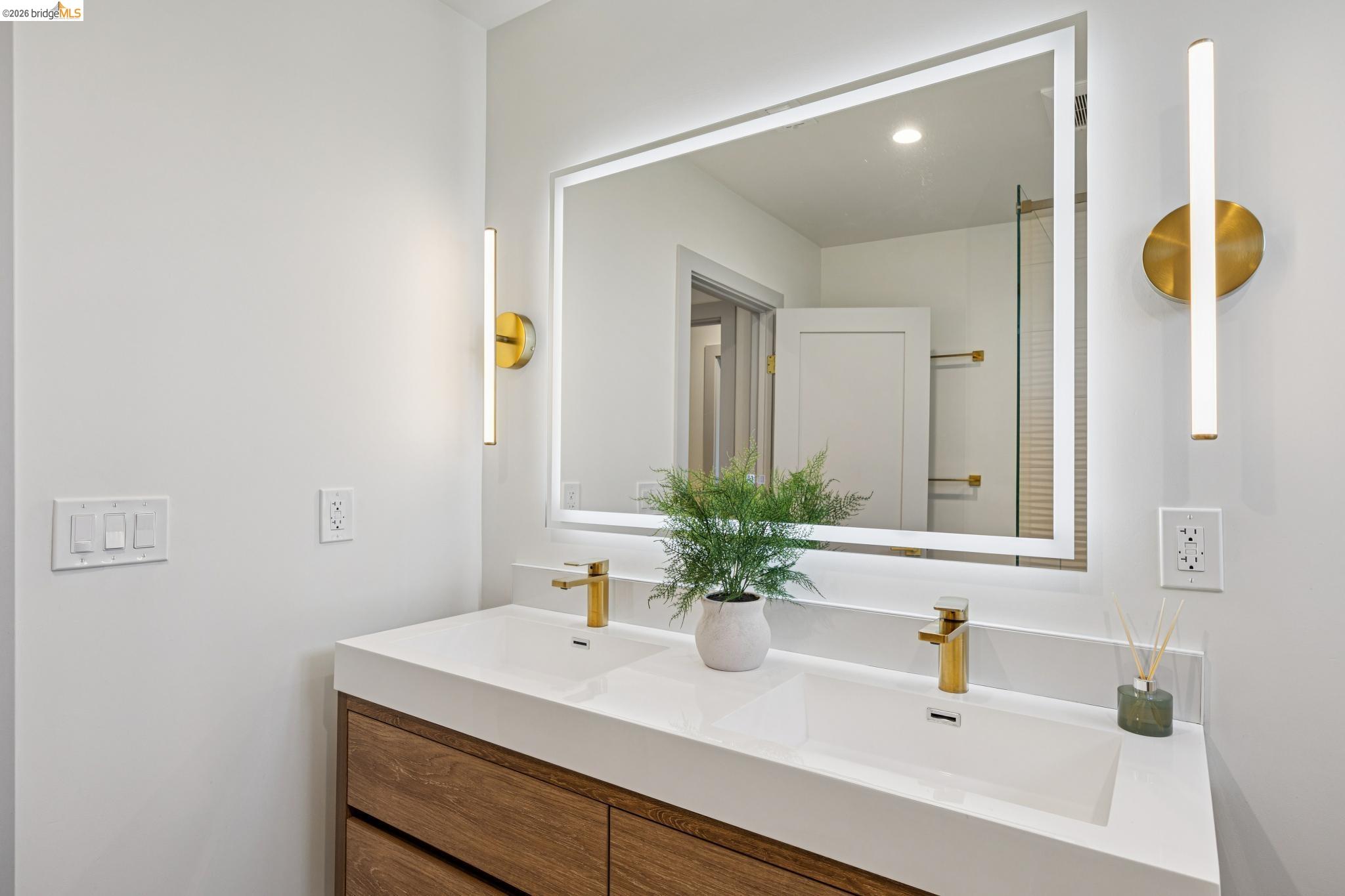 11 Belinda Court San Ramon, CA 94583 - Photo 25 of 33 Dual basin vanity with wood-finish cabinetry, white countertop, and gold-finish fixtures