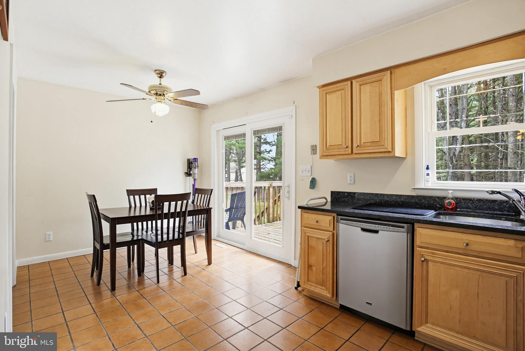 3703 Altondale Road Reisterstown, MD 21136 - Photo 11 of 34 a kitchen with stainless steel appliances granite countertop a stove a sink a dining table and chairs
