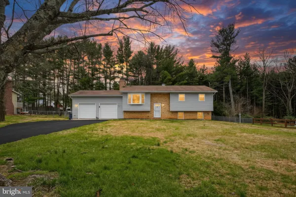 a view of a house with a yard and garage