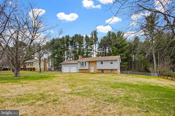 a view of a house with pool and a yard