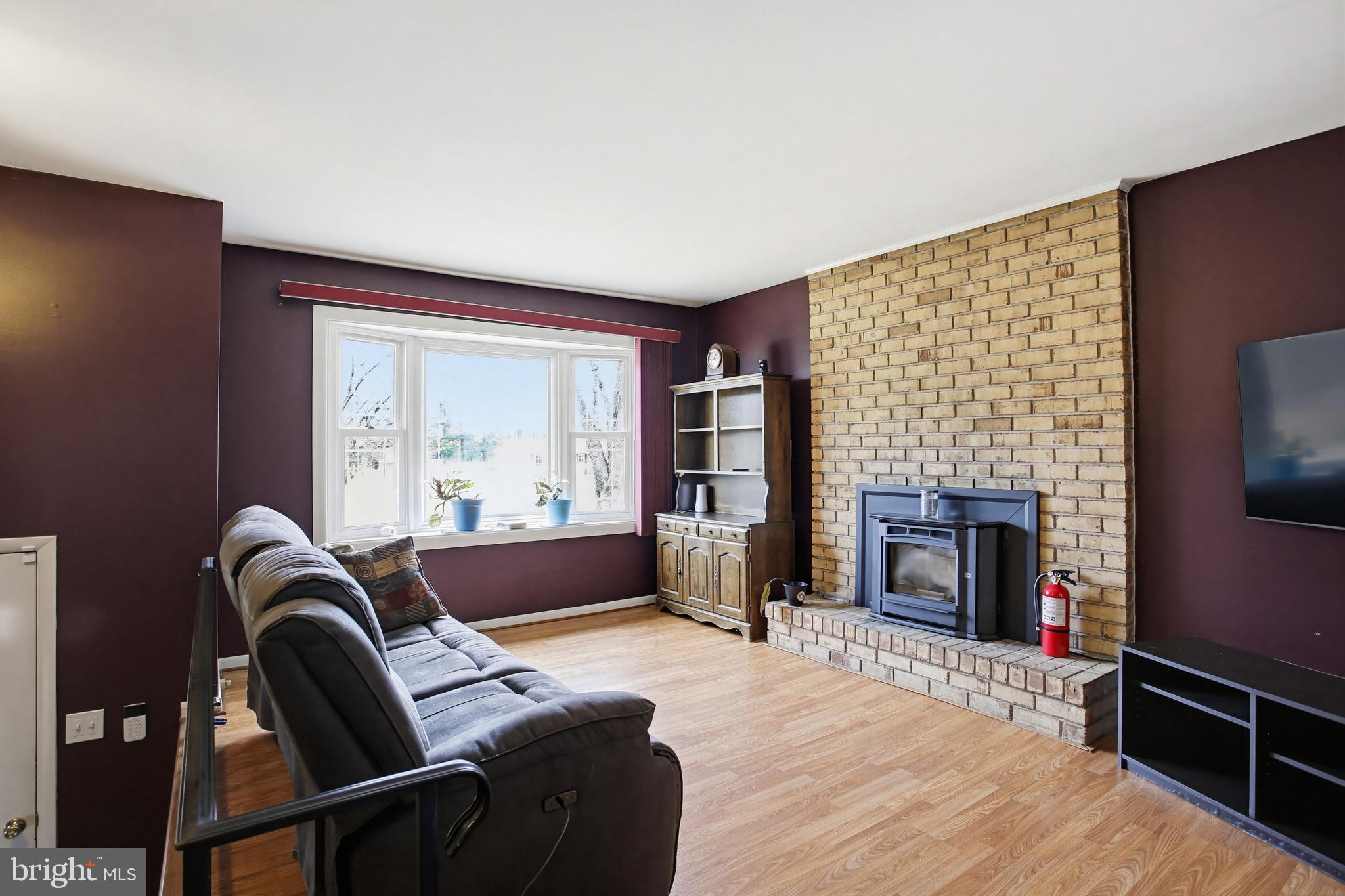 3703 Altondale Road Reisterstown, MD 21136 - Photo 5 of 34 a living room with furniture a fireplace and a flat screen tv
