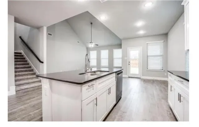 a kitchen with granite countertop a stove and a sink