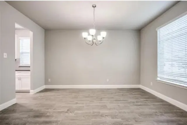 a view of wooden floor and windows in a room