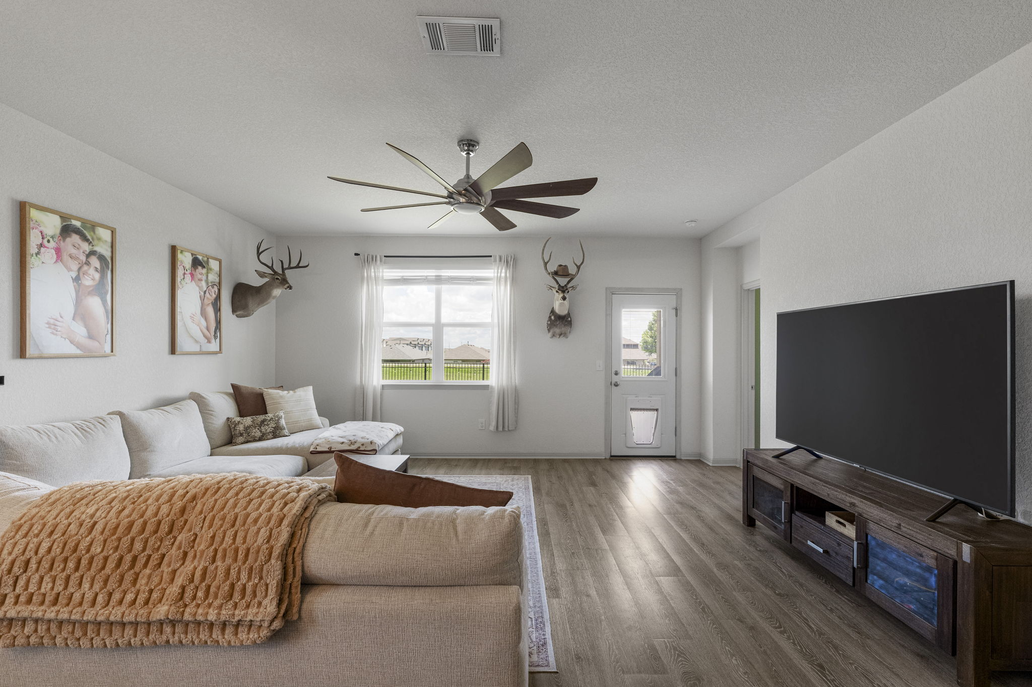 185 Struss Drive Georgetown, TX 78626 - Photo 9 of 23 Hardwood-style flooring and a ceiling fan create a comfortable, inviting atmosphere.