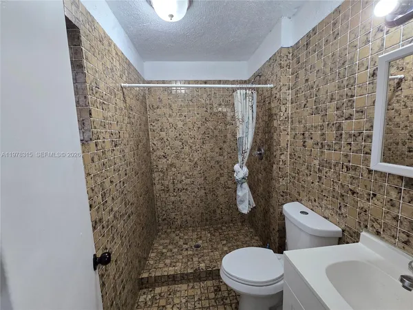 a white toilet sitting next to a bathroom sink