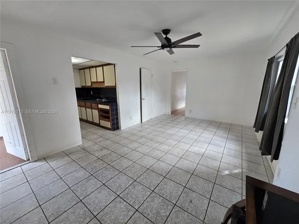 a view of an empty room and a window