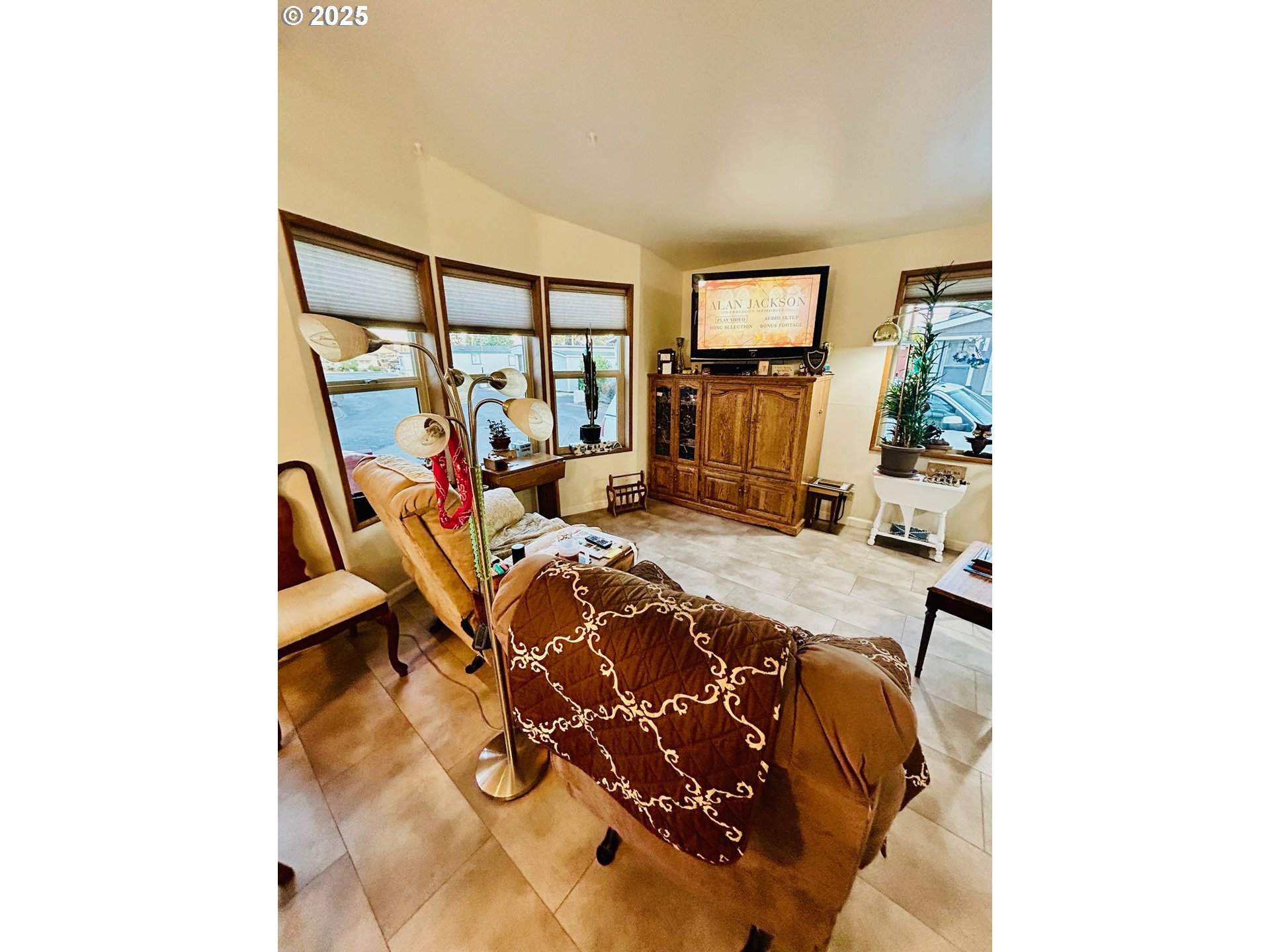 503 Southeast Sheridan Road, Unit 8 Sheridan, OR 97378 - Photo 22 of 38 a bed room with a bed and a flat screen tv