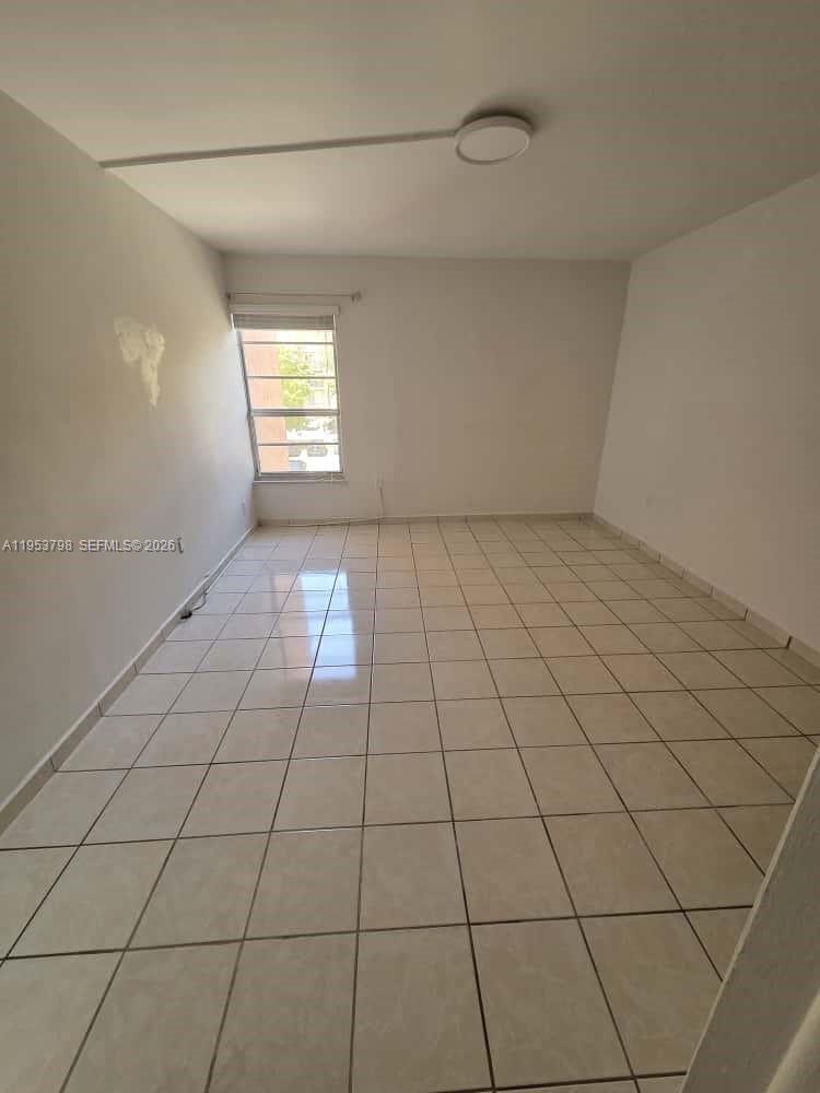 4717 Northwest 7th Street, Unit 30410 Miami, FL 33126 - Photo 2 of 8 a view of an empty room and window