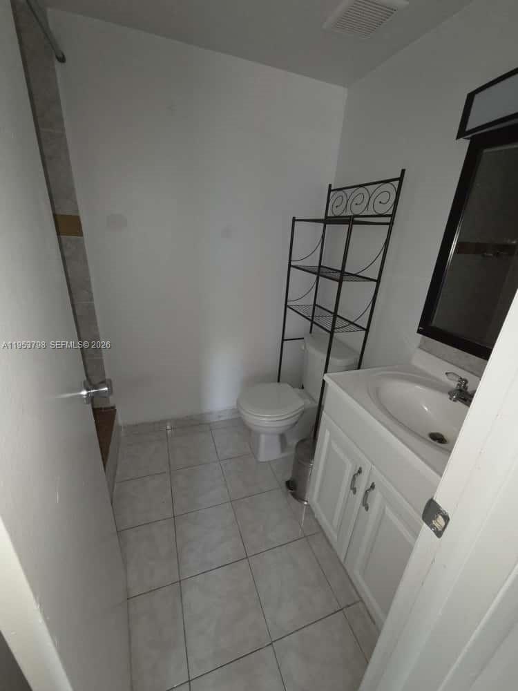4717 Northwest 7th Street, Unit 30410 Miami, FL 33126 - Photo 7 of 8 a bathroom with a toilet and a shower