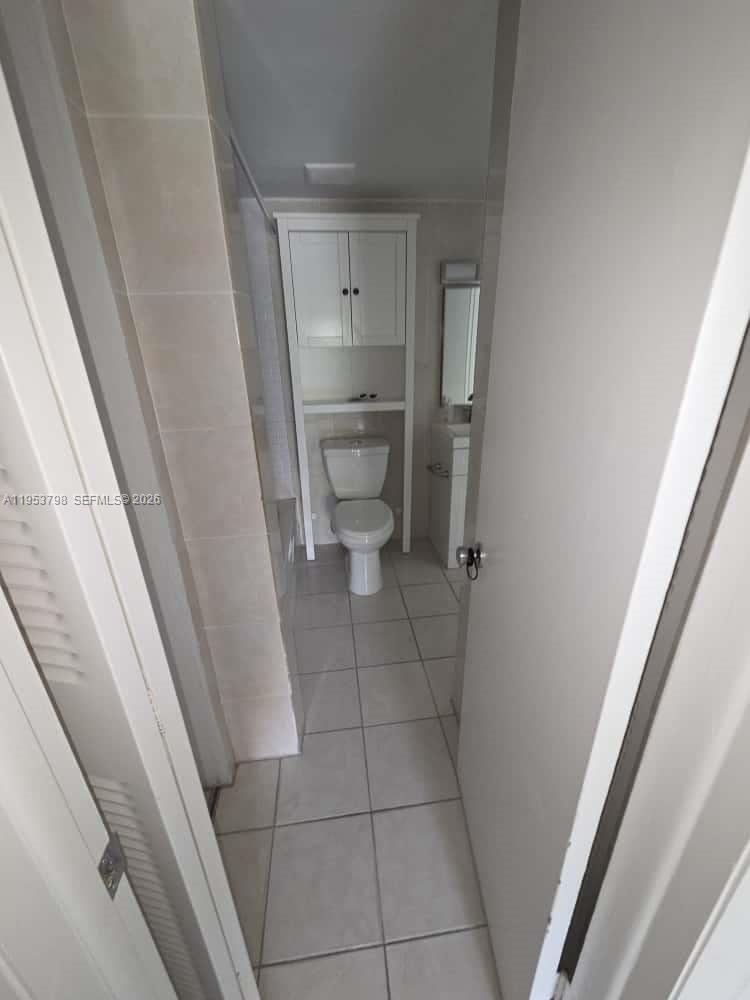 4717 Northwest 7th Street, Unit 30410 Miami, FL 33126 - Photo 8 of 8 a bathroom with a sink and toilet