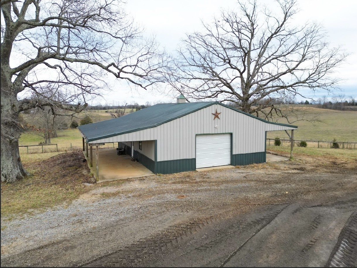 a backyard of a house with large trees and covered with snow