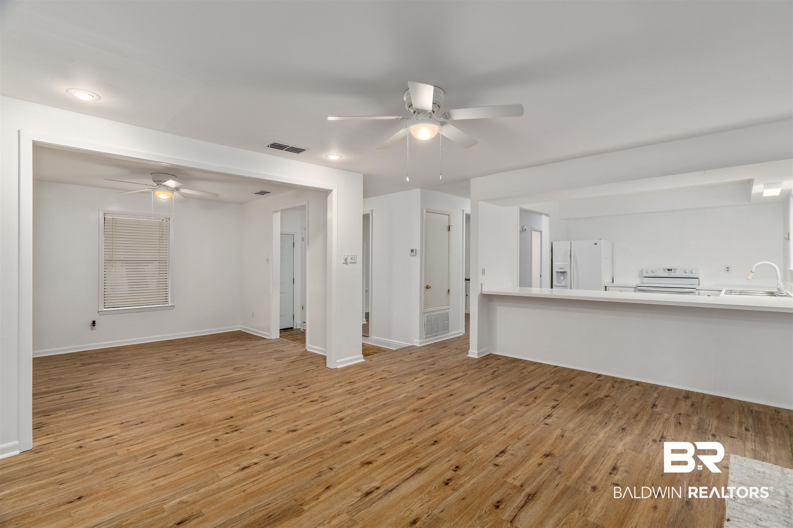 159 Montclair Loop Daphne, AL 36526 - Photo 8 of 18 Unfurnished living room with light wood finished floors and a ceiling fan