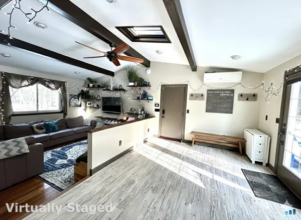 a large white kitchen with stainless steel appliances granite countertop a lot of counter space and wooden floors