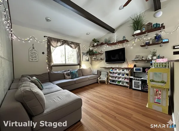 a living room with furniture and a flat screen tv