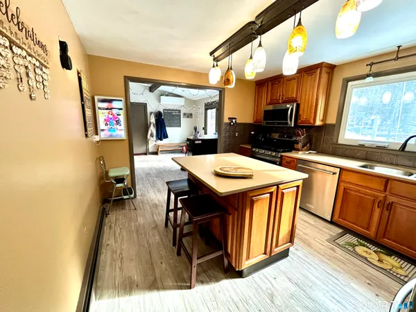a kitchen with a sink a counter top space and stainless steel appliances