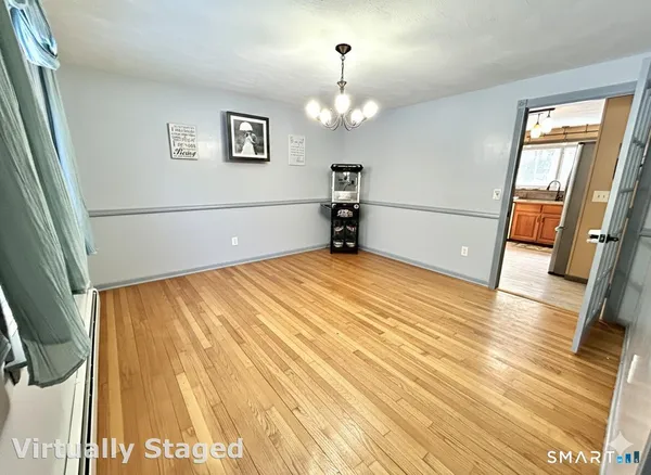 a view of a room with wooden floor