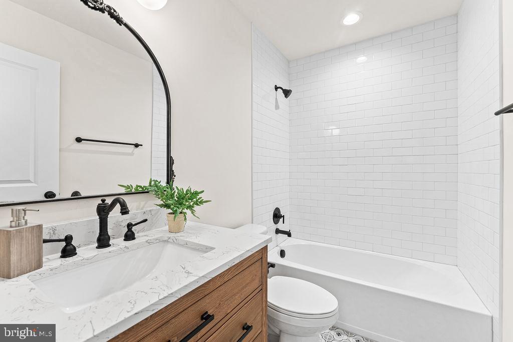 22366 Monrovia Road Orange, VA 22960 - Photo 35 of 53 a bathroom with a granite countertop sink a toilet and shower