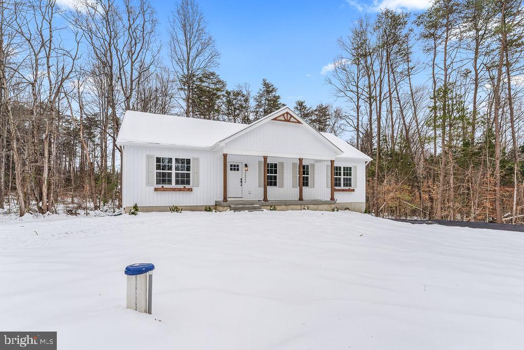 22366 Monrovia Road Orange, VA 22960 - Photo 46 of 53 a front view of a house with a yard covered in snow