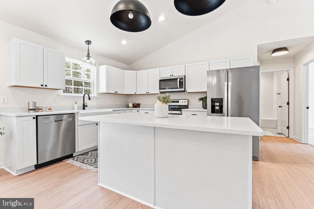22366 Monrovia Road Orange, VA 22960 - Photo 10 of 53 a kitchen with kitchen island granite countertop a sink a stove a refrigerator cabinets and a dining table
