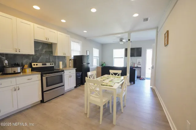 a kitchen with a table and chairs in it