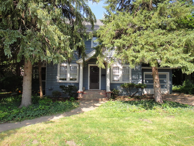 front view of a house with a tree in the yard