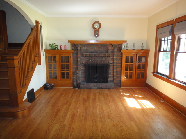 433 Normal Road DeKalb, IL 60115 - Photo 2 of 18 a view of an empty room with wooden floor fireplace and a window