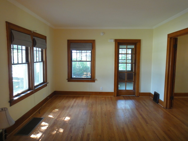 433 Normal Road DeKalb, IL 60115 - Photo 4 of 18 a view of an empty room with glass door and wooden floor