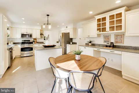 a kitchen with stainless steel appliances kitchen island granite countertop a sink and cabinets