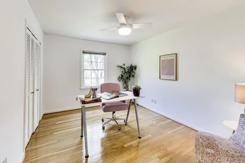 a work room with wooden floor and furniture