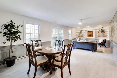 a view of a dining room with furniture and a potted plant