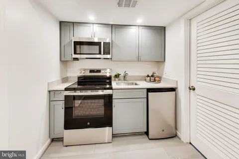 a kitchen with a sink stove and microwave