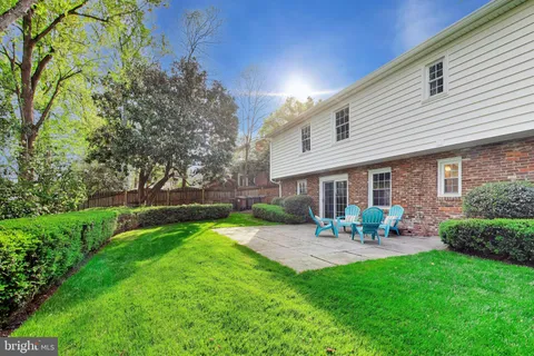 a view of a house with a yard and sitting area