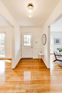 a view of a livingroom with wooden floor and a rug