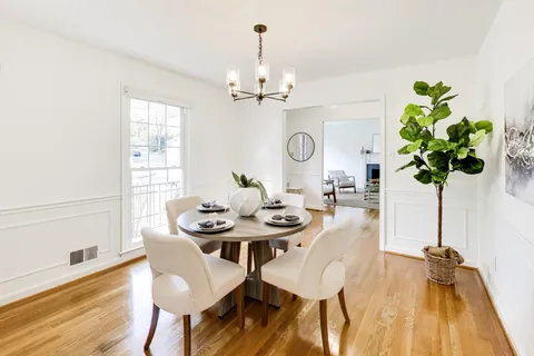a view of a dining room with furniture and a chandelier