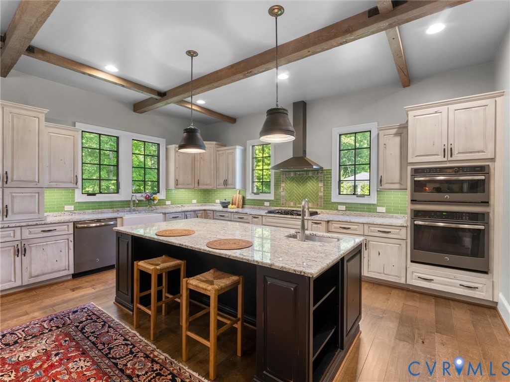 16131 Binley Road Midlothian, VA 23112 - Photo 32 of 99 a kitchen with kitchen island granite countertop a sink stove and wooden cabinets